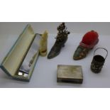Two pin cushion shoes, a carved ivory penguin, cracked, a Hsinghai harmonica, a silver matchbox