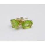 A pair of 9ct gold and peridot earrings, 0.7g