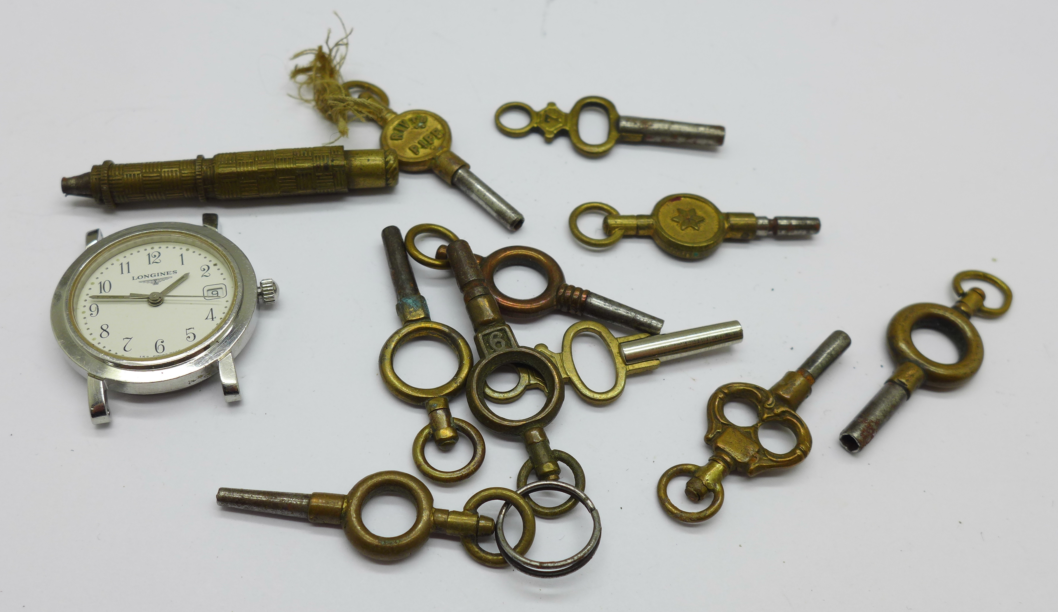 Pocket watch keys and a quartz Longines wristwatch, 24mm case