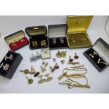 A collection of cufflinks and tie-pins