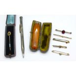 An amber and silver mounted cheroot holder, cased, an Eversharp pencil, five brooches and a