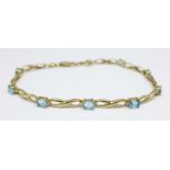 A 9ct gold and blue stone tennis bracelet, 4.4g