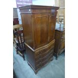 A mahogany serpentine cabinet on chest