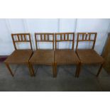 A set of four teak dining chairs