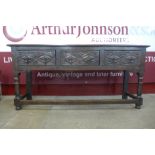 A 17th Century carved oak dresser base, with later Delft rack, 170cms h, 167cms w, 48cms d