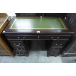 A small mahogany pedestal desk