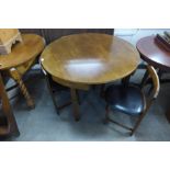 A hardwood circular dining table and four chairs