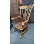 A Victorian style beech rocking chair