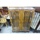 A walnut two door display cabinet