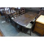 An Ercol Old Colonial dark elm refectory table and six ladderback chairs