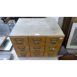 An oak nine drawer index cabinet