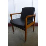 A teak and black vinyl elbow chair
