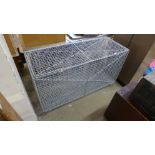 A galvanised wirework storage cage, 70cms h, 122cms w, 46cms d