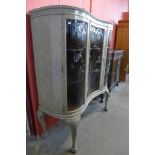 A Queen Anne style bleached walnut serpentine front display cabinet, 152cms h, 130cms w, 50cms d