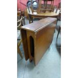 A teak drop-leaf table