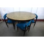 A painted teak extending dining table and four chairs