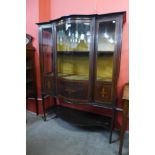 An Edward VII inlaid mahogany serpentine display cabinet, 160cms h, 122cms w, 46cms d