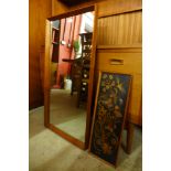 A teak framed mirror and a wall hanging plaque
