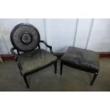 A French style ebonised bergere library chair and matching stool