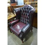 A red leather Chesterfield wingback armchair