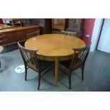 A teak extending dining table and four chairs