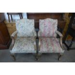 A pair of 1930's carved mahogany and upholstered Gainsborough style open armchairs