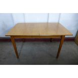 A teak extending dining table