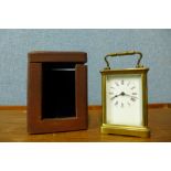 A brass carriage clock, 11cms h, with brown Morocco leather travelling case