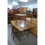 A teak extending dining table and four chairs