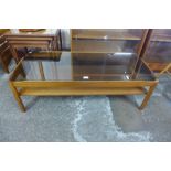 A teak and glass topped coffee table