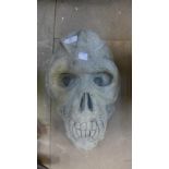 A concrete primate skull garden ornament