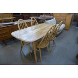 An Ercol Blonde Windsor elm and beech plank dining table and four chairs