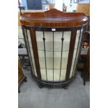 A mahogany bow front display cabinets