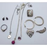 Three silver brooches, a silver and garnet ring with matching earrings, silver pendants, etc.
