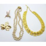 A gilt metal collarette, a double strand faux pearl necklace, a bird brooch and a leaf brooch