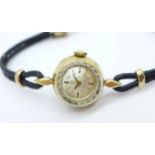 A lady's hallmarked 9ct gold Omega wristwatch, the 'shoelace' strap mount also marked 9ct gold
