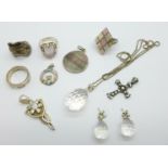 Four silver pendants, a silver chain with pendant and matching earrings, three silver rings, two