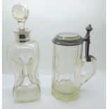 A silver mounted decanter, a/f, and an etched glass tankard