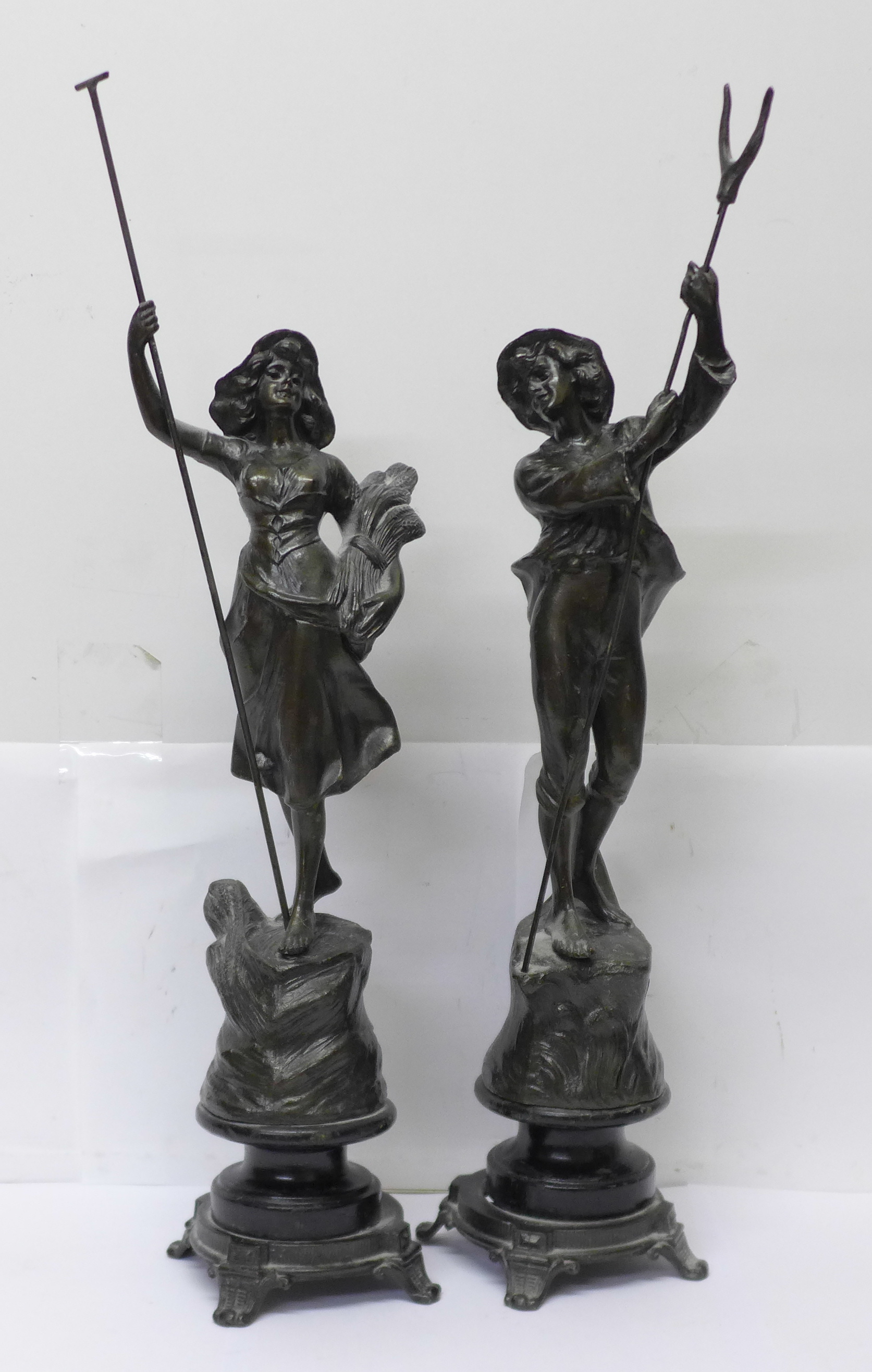 A pair of spelter figures, farm girl and boy, 39.5cm