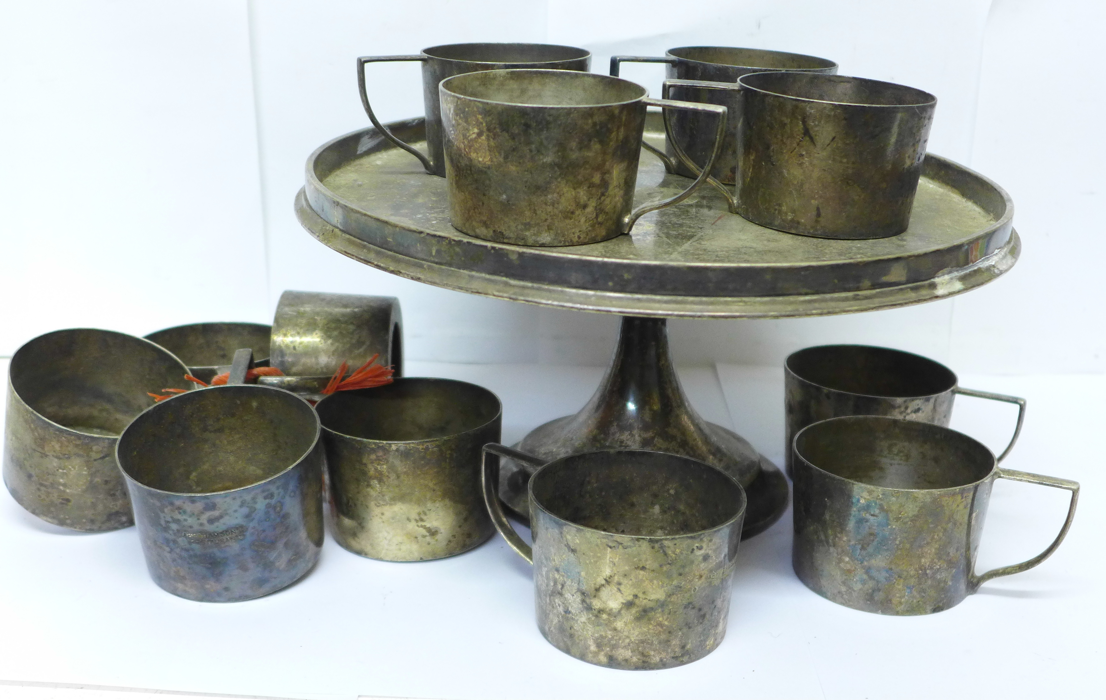 A Geo. Abrahamson Newman Galleries set of twelve silver plated cup holders and stand
