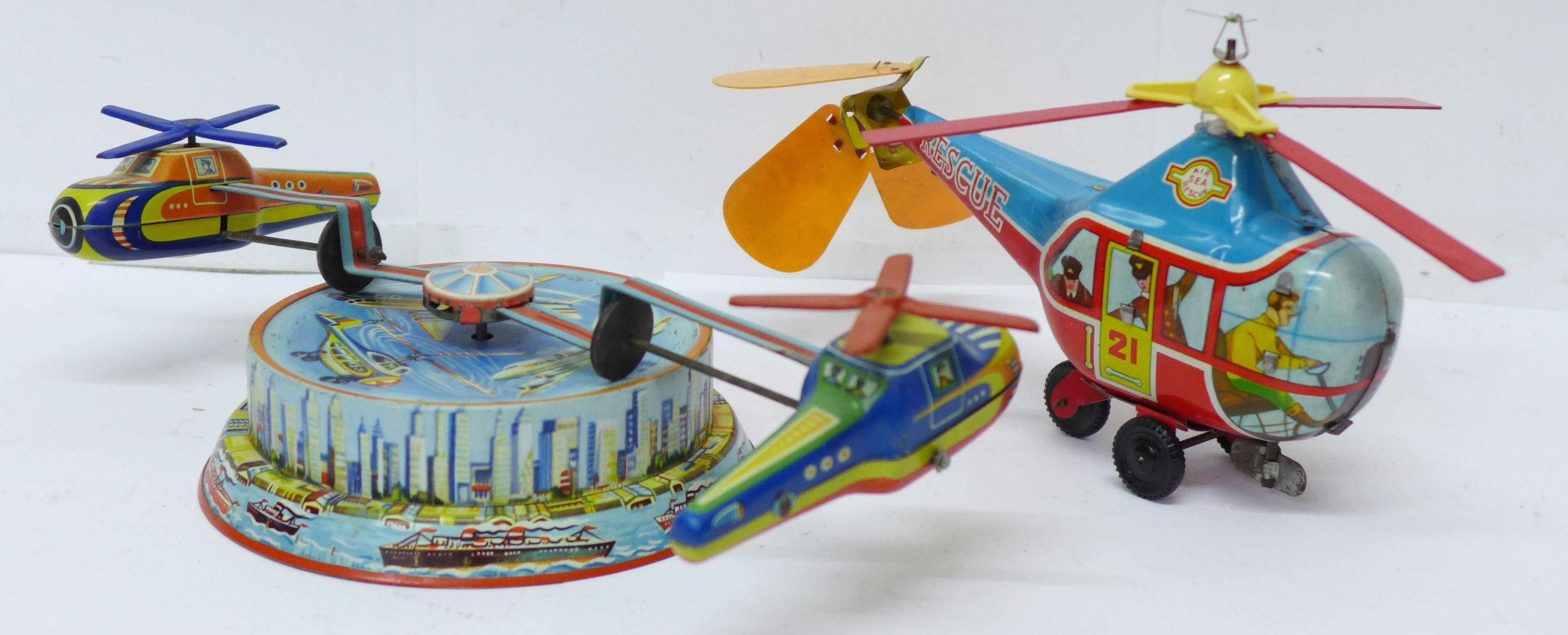 A tin-plate clockwork helicopter toy, made in Western Germany, and one other tin-plate clockwork toy