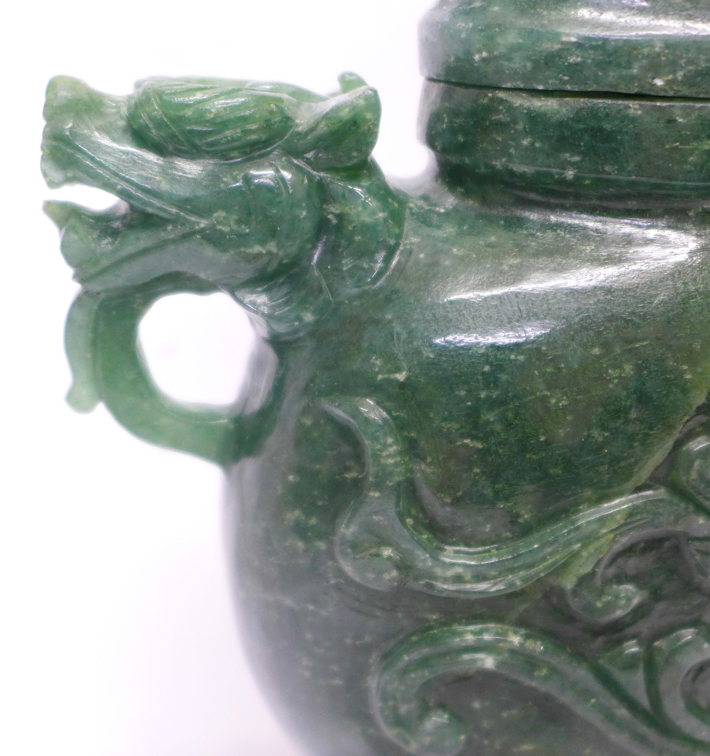 A carved green stone urn with lid, small losses to the lid and one ring missing, 23cm - Image 3 of 6