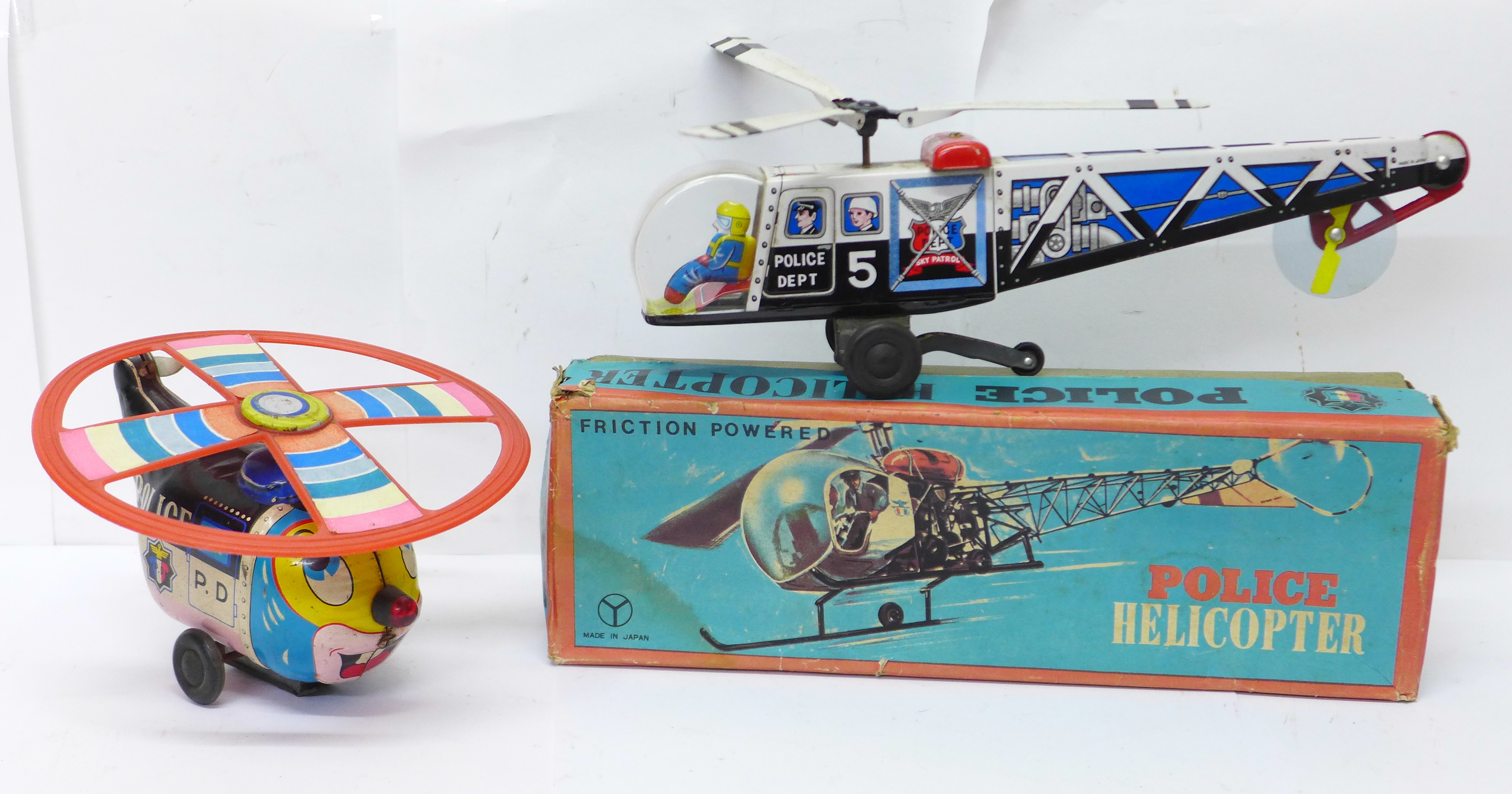 A Friction Powered tin-plate Police Helicopter, made in Japan, boxed, and a T.N. made in Japan tin-