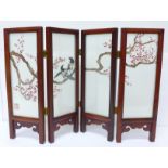 A circa mid 20th Century Chinese table screen with embroidered silk panels, decorated with two