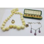 An ivory bead necklace, a cased set of six enamelled studs, enamel necklace and two pendants