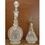 A silver mounted glass decanter and a cut glass decanter, (2)