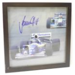 A framed photograph of Damon Hill, signed