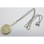 A miniature silver hand mirror, Birmingham 1921, on a silver chain