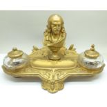 A c.1900 metal inkstand with two glass inkwells, one top a/f, mounted with a bust marked Cornelle