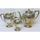 A three piece silver plated and embossed tea service